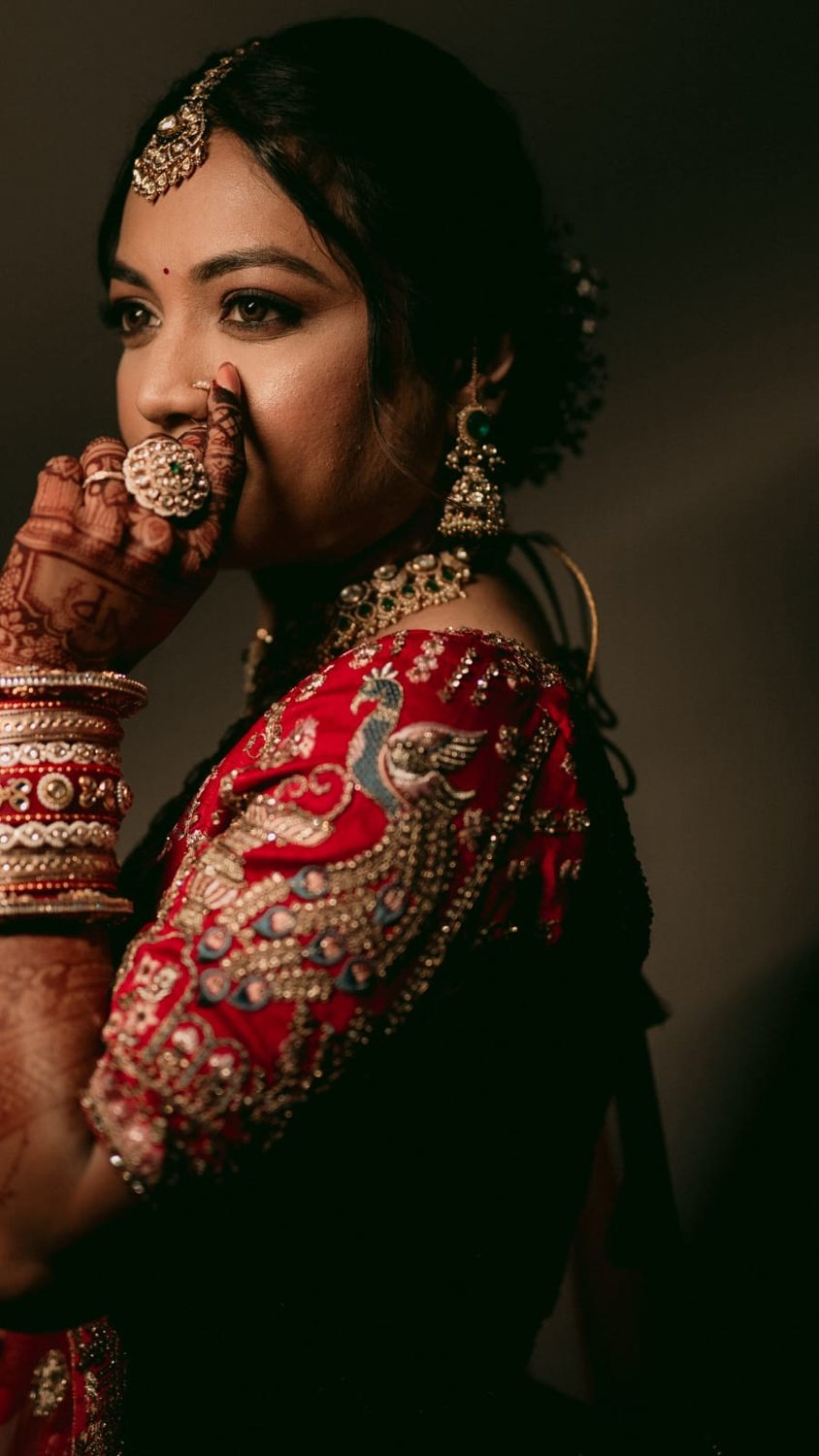 Bride in red lehenga with peacock embroidery